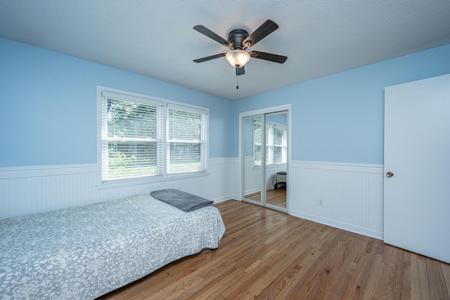 2847 Limestone Blvd, Charleston, SC 29414 - bedroom featuring wainscoting, wood finished floors, a closet, and ceiling fan