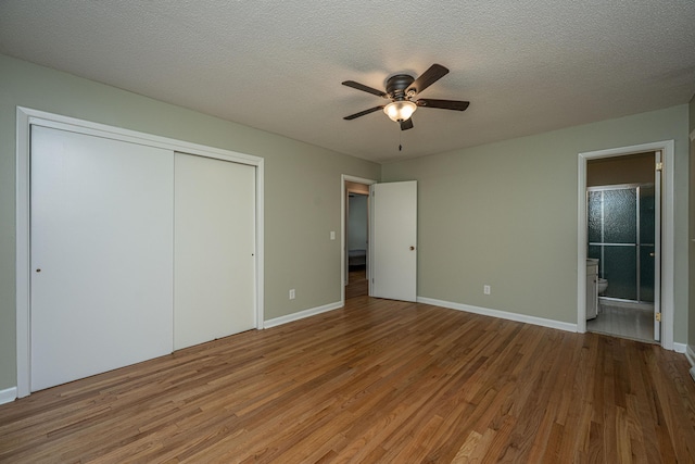2847 Limestone Blvd, Charleston, SC 29414 - unfurnished bedroom featuring wood finished floors, a closet, connected bathroom, a textured ceiling, and a ceiling fan