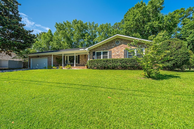 2847 Limestone Blvd, Charleston, SC 29414 - ranch-style house featuring a front yard, a garage, brick siding, and driveway