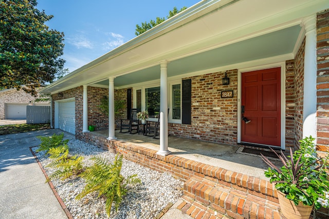 2847 Limestone Blvd, Charleston, SC 29414 - doorway to property with covered porch, brick siding, driveway, and an attached garage