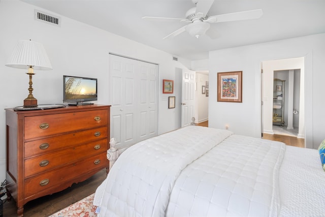 bedroom featuring dark hardwood / wood-style flooring, a closet, and ceiling fan