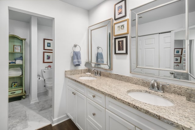 bathroom featuring vanity and toilet