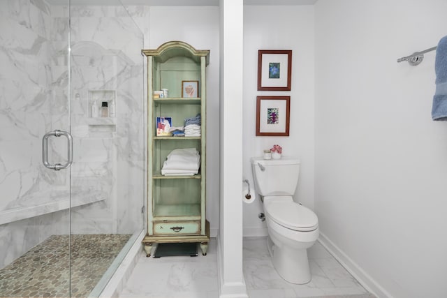 bathroom with a shower with door and toilet