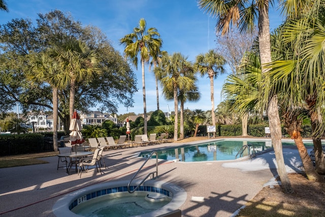 view of pool with a hot tub and a patio