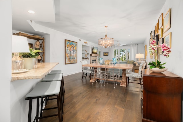 dining area with dark hardwood / wood-style floors and ceiling fan