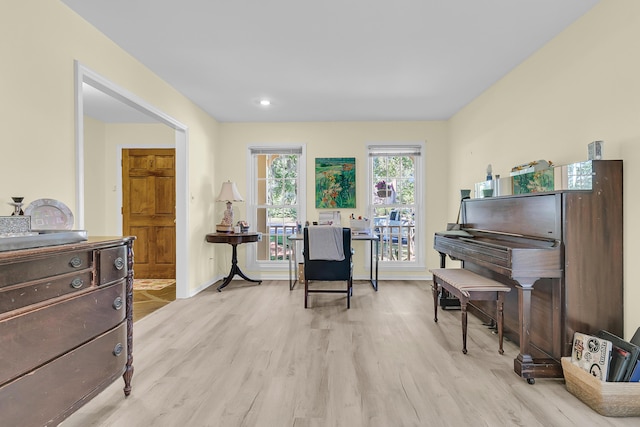 living area featuring light wood-style flooring and baseboards