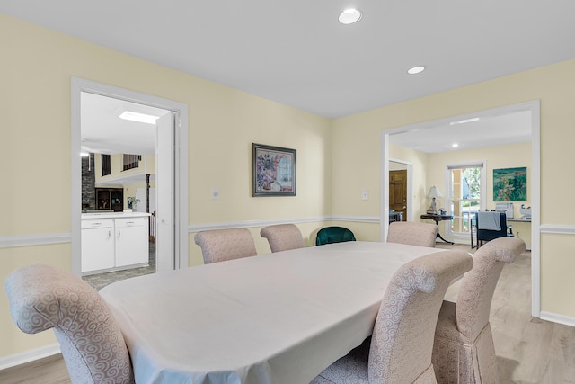 dining room featuring light wood-style flooring, recessed lighting, and baseboards