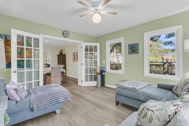 bedroom with french doors, light wood-type flooring, baseboards, and ceiling fan
