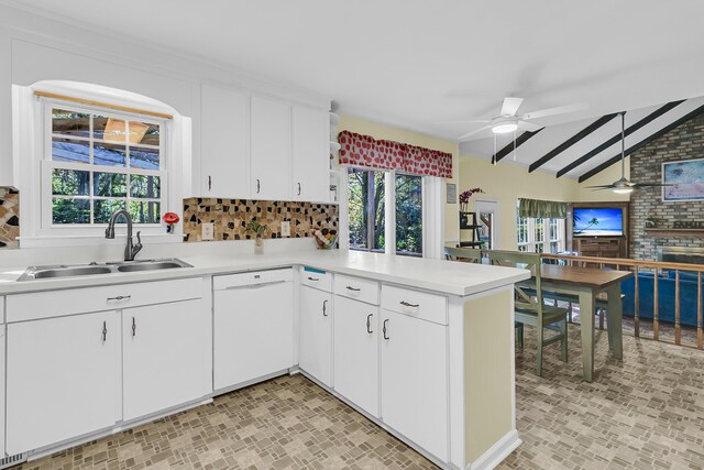 kitchen featuring dishwasher, a sink, a ceiling fan, light countertops, and a peninsula