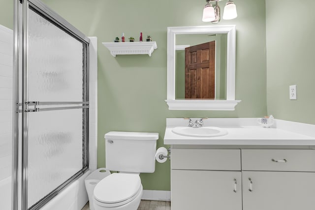 full bathroom with a shower with shower door, vanity, and toilet