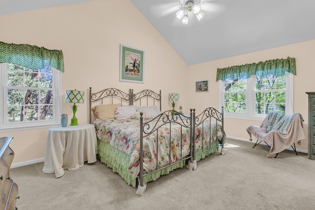 carpeted bedroom featuring baseboards, lofted ceiling, and a ceiling fan