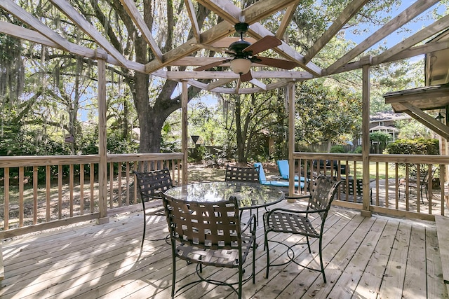 wooden deck with ceiling fan and outdoor dining area