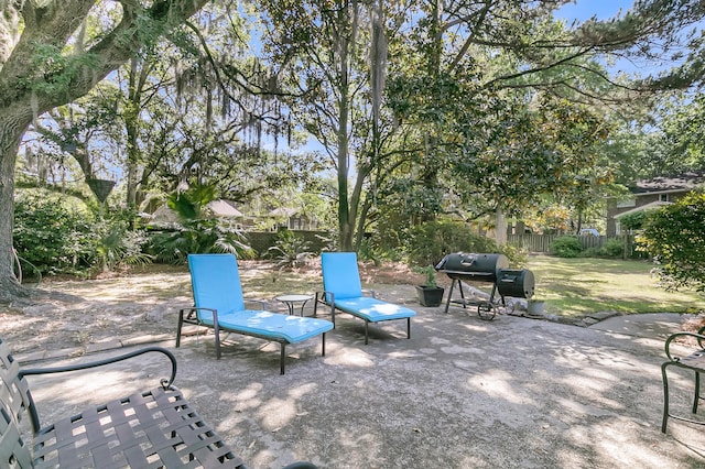 view of patio with area for grilling and fence