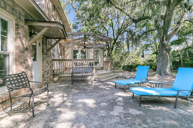 view of patio / terrace with a deck and a ceiling fan