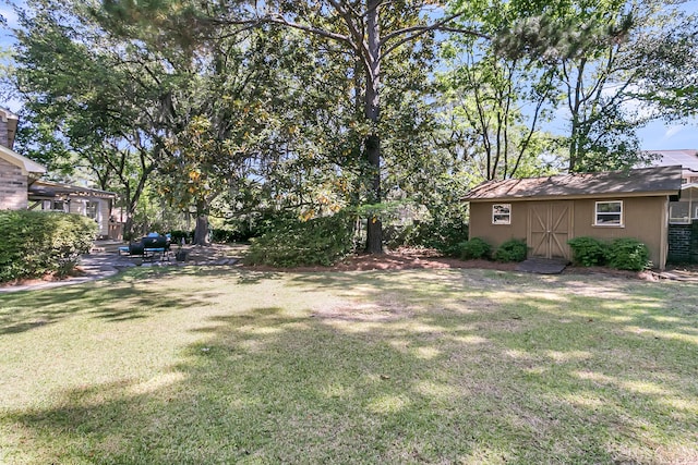view of green lawn featuring an outdoor structure and a shed