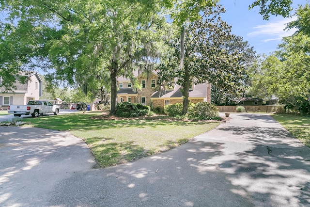 view of front of property with driveway and stone siding