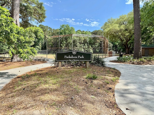 community / neighborhood sign with fence