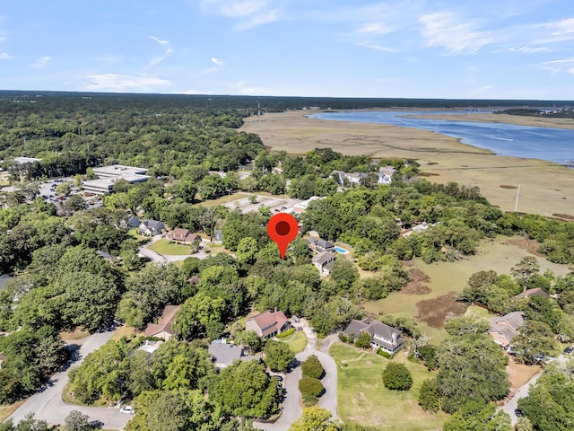 aerial view of a nearby body of water and a forest
