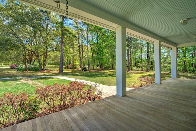 deck featuring a yard and covered porch