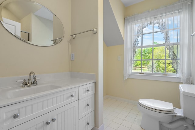 bathroom with toilet, tile patterned floors, vanity, and baseboards