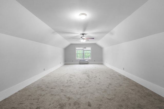 additional living space featuring carpet floors, ceiling fan, vaulted ceiling, and baseboards