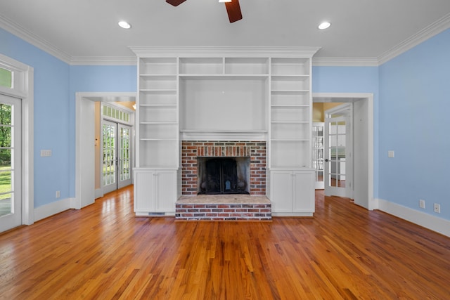 unfurnished living room featuring crown molding, a healthy amount of sunlight, baseboards, and a ceiling fan