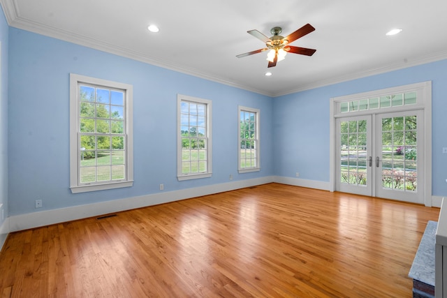 unfurnished living room with light wood-style floors, visible vents, crown molding, and a healthy amount of sunlight