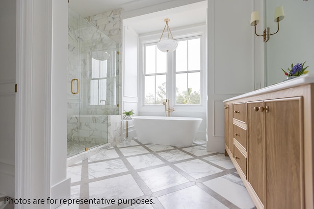 bathroom with vanity and shower with separate bathtub