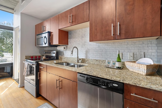 1 Cool Blow St Unit 124, Charleston, SC 29403 - kitchen with stainless steel appliances, a sink, light wood finished floors, decorative backsplash, and light stone counters