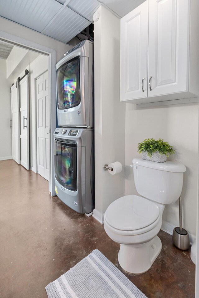 1 Cool Blow St Unit 124, Charleston, SC 29403 - bathroom with stacked washer / drying machine, concrete flooring, baseboards, and toilet