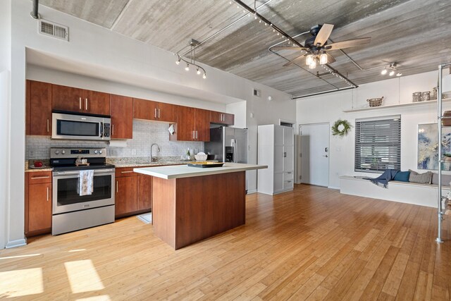 1 Cool Blow St Unit 124, Charleston, SC 29403 - kitchen featuring stainless steel appliances, open floor plan, light countertops, a ceiling fan, and decorative backsplash