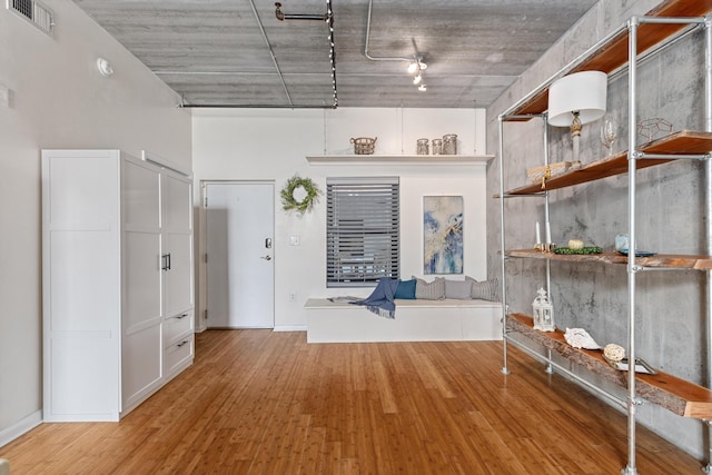 1 Cool Blow St Unit 124, Charleston, SC 29403 - unfurnished living room featuring wood finished floors and track lighting