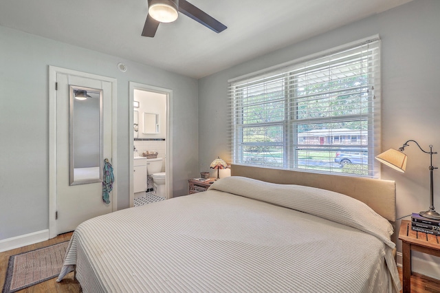 bedroom featuring baseboards, a ceiling fan, connected bathroom, and wood finished floors