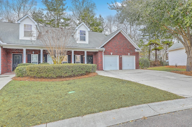 cape cod home with a garage and a front yard