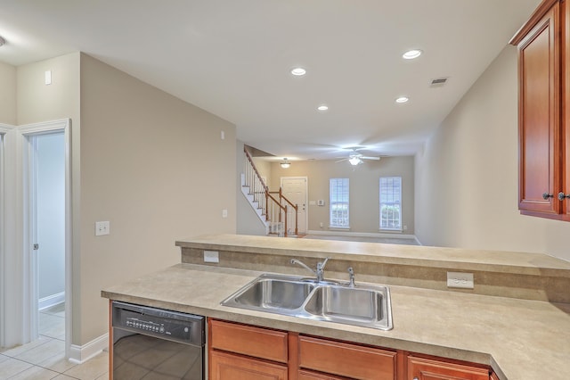 kitchen featuring sink, light tile patterned floors, black dishwasher, and ceiling fan