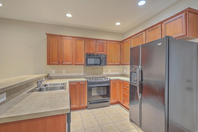 kitchen featuring sink, black appliances, kitchen peninsula, and light tile patterned floors