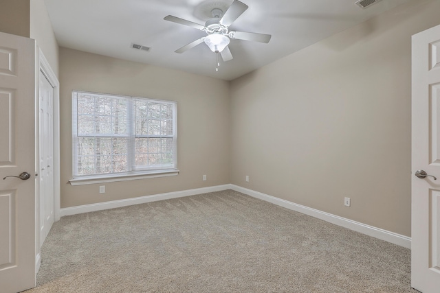 unfurnished bedroom with light colored carpet and ceiling fan