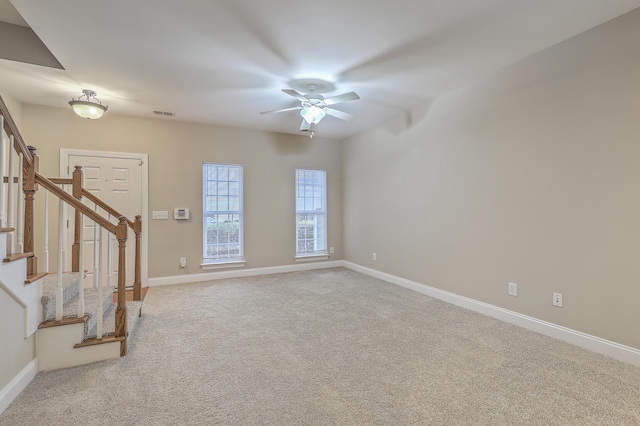 carpeted spare room with ceiling fan