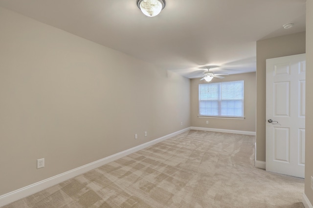 unfurnished room featuring ceiling fan and light carpet