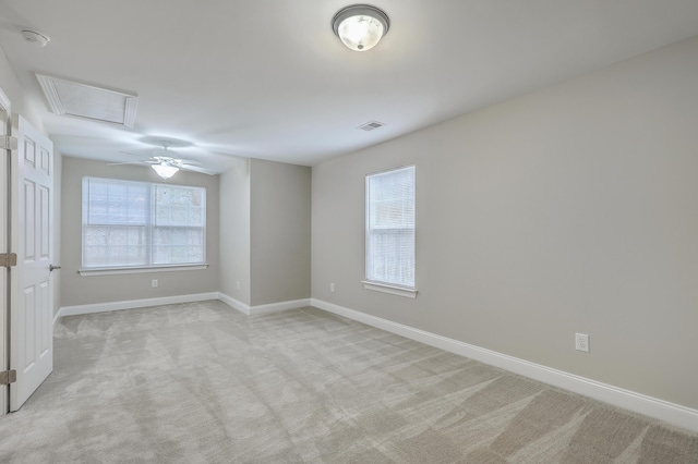 empty room featuring plenty of natural light and light carpet