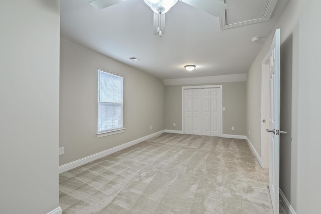 unfurnished bedroom with light colored carpet, a closet, and ceiling fan