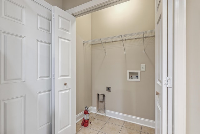 laundry area featuring electric dryer hookup, hookup for a washing machine, and light tile patterned floors