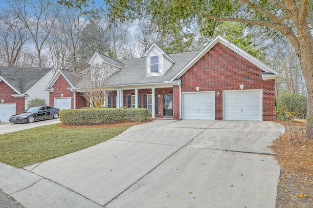 cape cod-style house featuring a garage and a front lawn