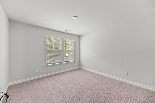 unfurnished room featuring carpet floors and baseboards