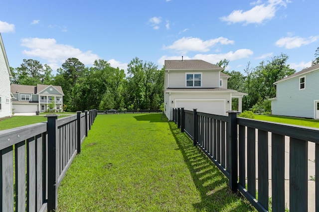 view of yard with a garage and driveway