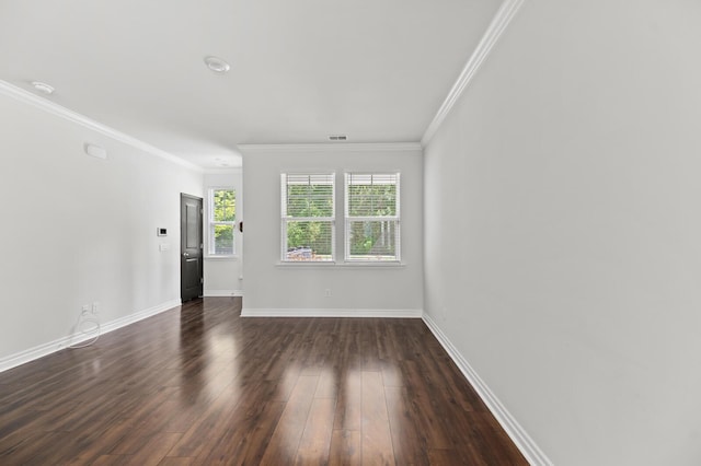 unfurnished living room featuring crown molding, dark wood finished floors, and baseboards