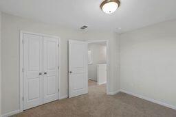 unfurnished bedroom with carpet floors and a closet