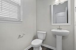 bathroom with wood-type flooring and toilet