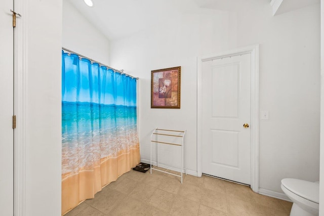 full bath with toilet and baseboards