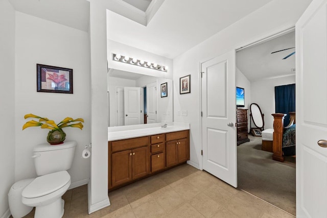 bathroom with toilet, baseboards, and vanity